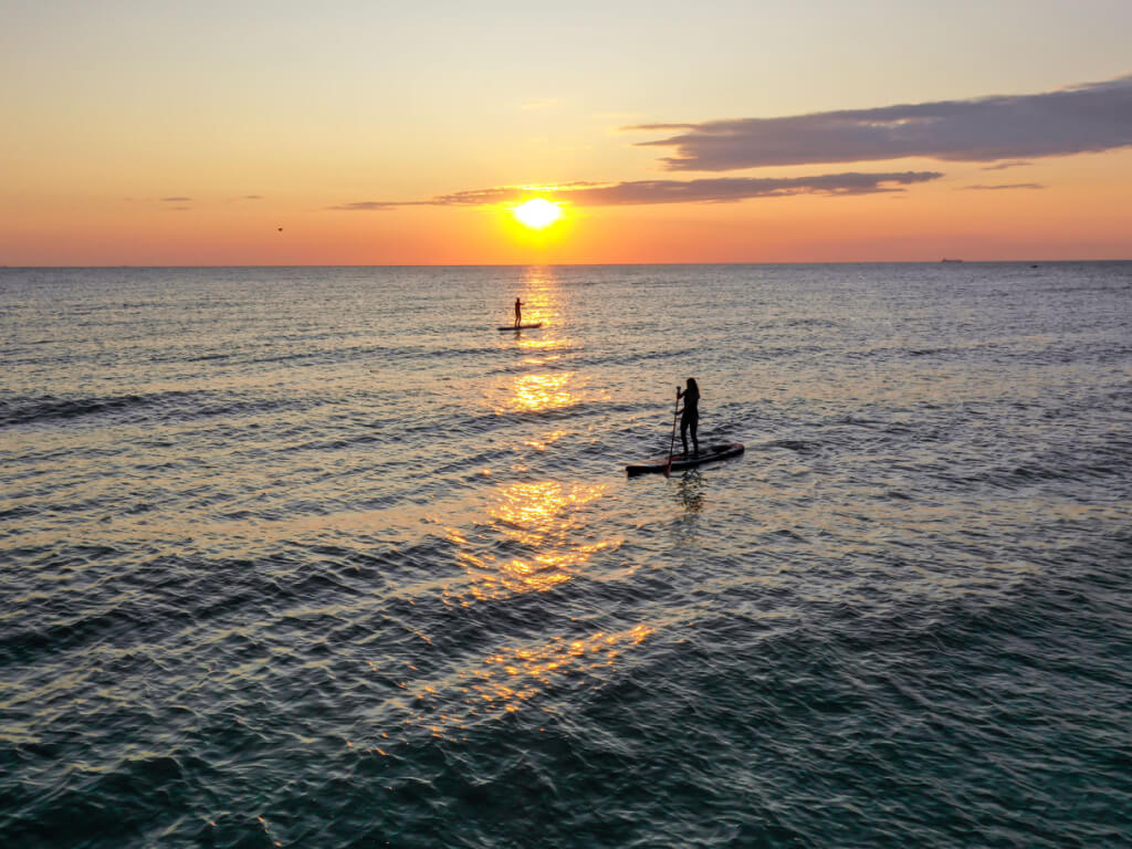 sunset paddle boarding